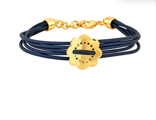 Maya bracelet with 14k gold dipped single flower charm and adjustable lobster claw closure on navy cord by Asha.

 6.7in to 7.5in