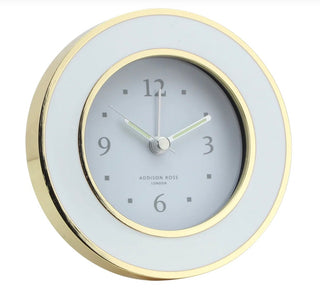 White enamel finished with gold alarm clock by Addison Ross. This clock features a silent sweep movement making it the perfect addition to a bedside table.