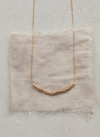 Columba Necklace by Abacus Row.
A segment of Abacus Row signature beads on a simple chain. Length – 18"

Materials – 14k gold-filled beads, chain and findings