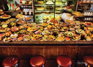 Close up picture of picture of a diner counter filled with food.