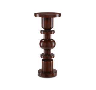 The Sasha Walnut Drinks Table is made of mahogany in a dark walnut finish. A juxtaposition of geometric shapes