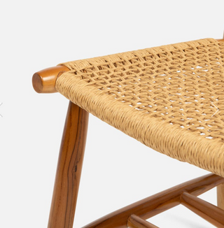 Made Goods Corenne teak dining chair. Danish design with natural woven fiber wrapped back and woven seat. Detail view of woven seat and detail of rounded teak legs.