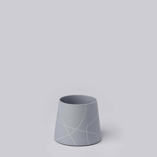 Grey vase with white outline design.
