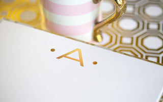 Notepad 8.5”x7” with a gold foil  A printed on the top center of the pad by Black Ink