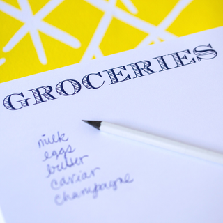 Notepad 8.5” x 7” with Groceries printed in the  center of the pad 
